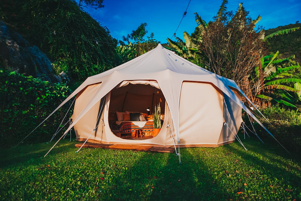 heros-img Spacious glamping tent set in a vibrant garden in São Paulo, Brazil, offering a luxurious camping experience surrounded by nature.